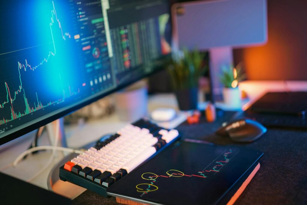 Modern workspace with screens displaying cryptocurrency market data and trends.