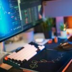 Modern workspace with screens displaying cryptocurrency market data and trends.